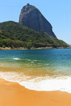 Mountain Sugarloaf and empty red beach blue sea, Rio de Janeiro,
