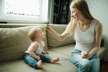 mother feeding baby with a spoon