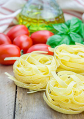 Raw tagliatelle pasta on the wooden table