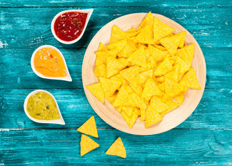 Plate of nachos with different dips