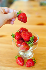 Ripe red strawberries on wooden table