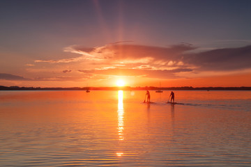 Fototapeta na wymiar Sunset Stand up Paddling at Lake Chiemsee