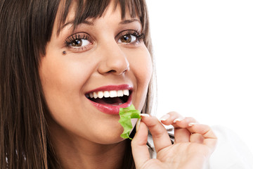 Young woman eating green salad