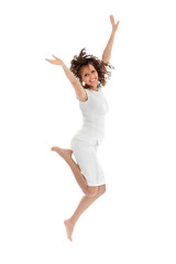 Fototapeta premium Young woman jumping on white background