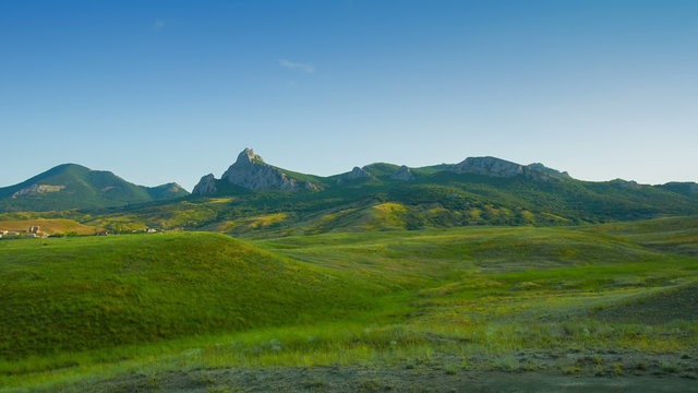 Scenic View of the Mountains and Green Meadow
