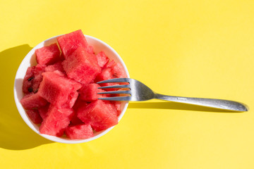 pieces watermelon in bowl with fork