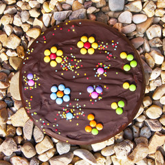 Chocolate birthday cake decorated with flowers