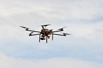 Drone with camera hovering in the sky