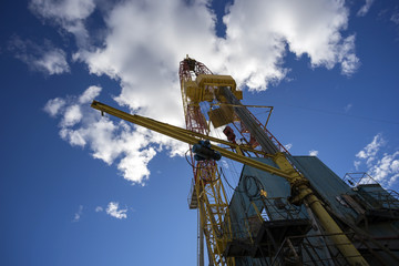 Oil rig on blue sky background