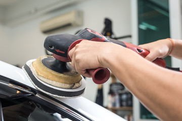 Car polishing series : Worker waxing white car