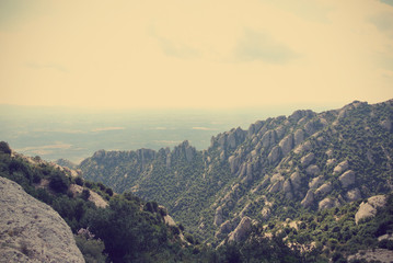 Strange rugged landscape of the Montserrat mountain, in Catalonia, Spain. Image filtered in faded, washed out, retro style with soft focus and dark vignette; nostalgic vintage travel concept. - 89304389