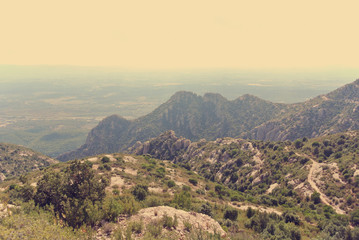 Panoramic view on the rugged landscape of the Montserrat mountain, in Catalonia, Spain. Image filtered in faded, washed out, retro, style with soft focus; nostalgic vintage travel concept.