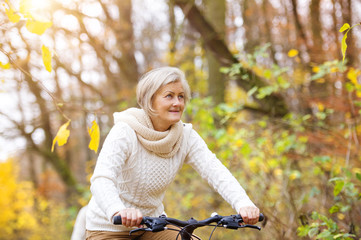 Active senior woman riding bike