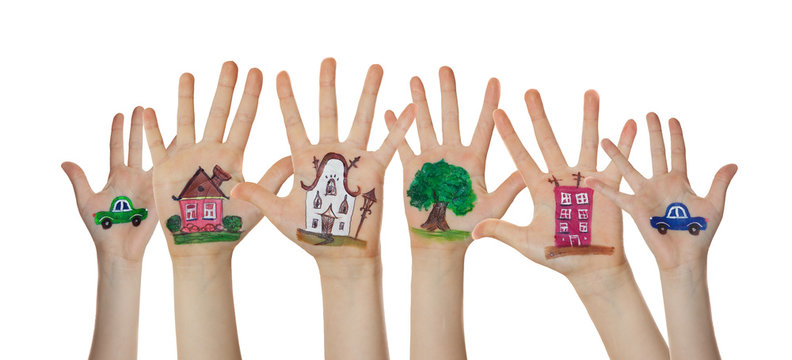 Houses, car and trees painted on children hands. Hands raised up