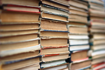 Stacks of old hardback and paperback books. Background image