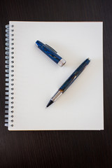 Blank notepad on office wooden table