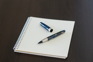 Blank notepad on office wooden table