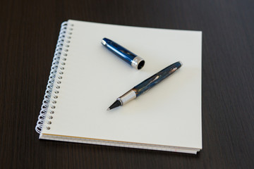 Blank notepad on office wooden table