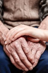 Hands of the old man and a young woman.. toning