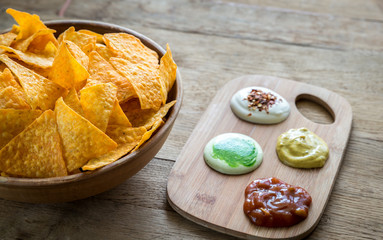 Cheese nachos with different types of sauce