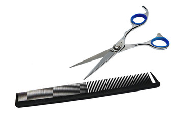 Scissors and comb on a white background 