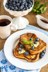 French toasts with fresh blueberries and maple syrup
