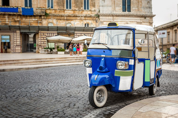 Ape in a beautiful Italian city square