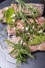 roasted lanb fillets with herbs in the pan