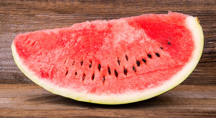 Slices of watermelon on old wooden background