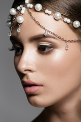 Beautiful woman's face with gorgeous make-up close-up