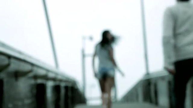 Woman attacked by man on bridge violence out of focus