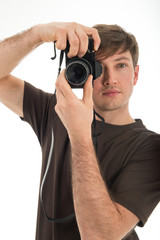 Young professional photographer shooting in the studio