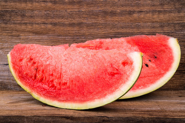 Slices of watermelon on old wooden background