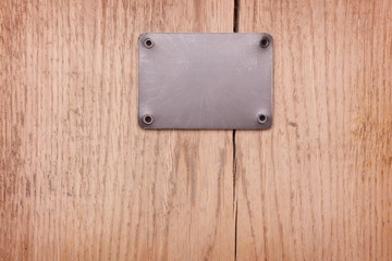 A Wooden background with metal label