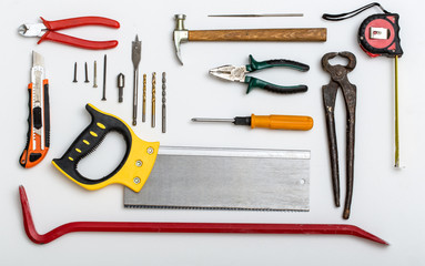 Set of different used repair tools on white plate
