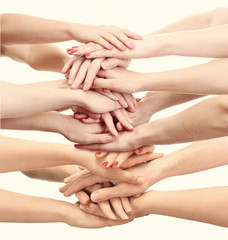 People's hands together on light background