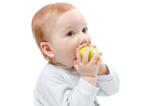 Baby Eating Green Apple. Studio Half Length Portrait , Isolated On A White Background