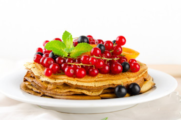 Pancakes with berries and fruits: apricot, red, blackcurrant