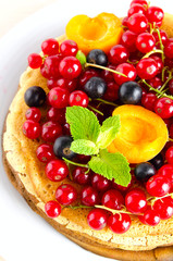 Pancakes with berries and fruits: apricot, red, blackcurrant