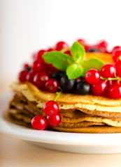 Pancakes with berries and fruits: apricot, red, blackcurrant
