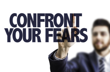 Business man pointing the text: Confront Your Fears