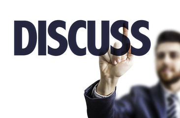 Business man pointing the text: Discuss