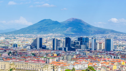 aerial view of centro direzionale business district in naples with mount vesuvius behind.