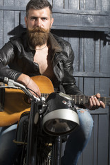 Fototapeta na wymiar Biker man with guitar