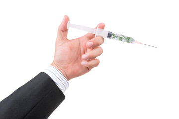 hand holding syringe filled with currency