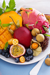 Exotic fruits on white plate