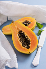 Cut papaya on a blue table