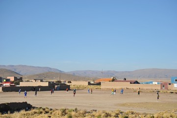 Obraz premium Residents of a Bolivian mountain village play football.