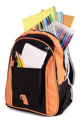 School satchel bag backpack with various books pencils crayons and study equipment isolated on white background photo