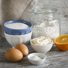 raw ingredients - flour, eggs, butter, sugar, orange - to cook orange cake. Ingredients for baking. Ingredients for the dough.